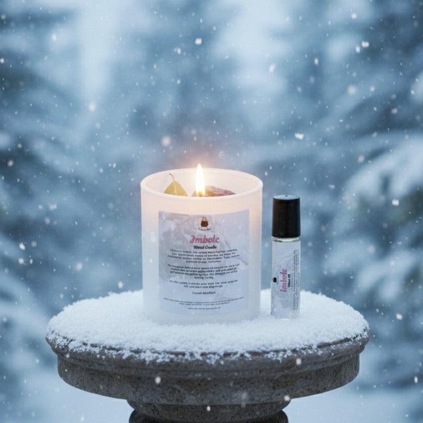 Imbolc ritual candle and essential oil placed on snowy pedestal outdoors in winter forest