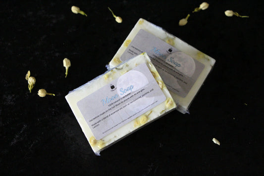 Handcrafted Moon Soap bars with botanicals on black velvet, sustainable ritual goods