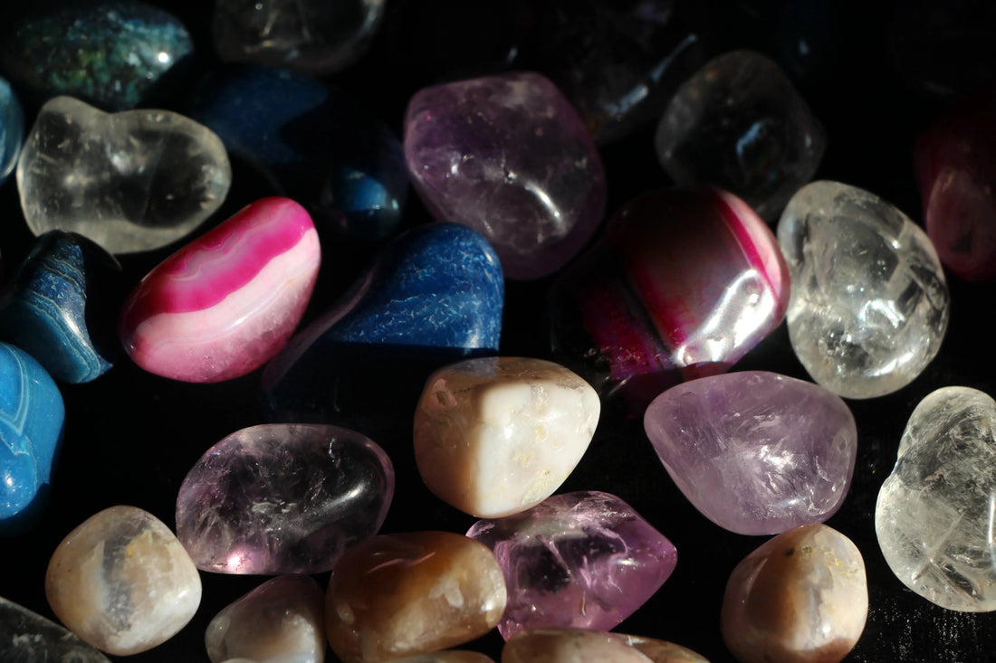 Assorted polished crystals and gemstones in natural light for intention rituals