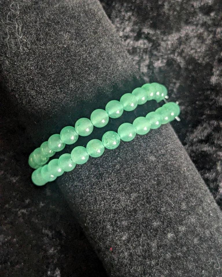 Green crystal bead bracelets on black velvet background, handmade gemstone jewelry
