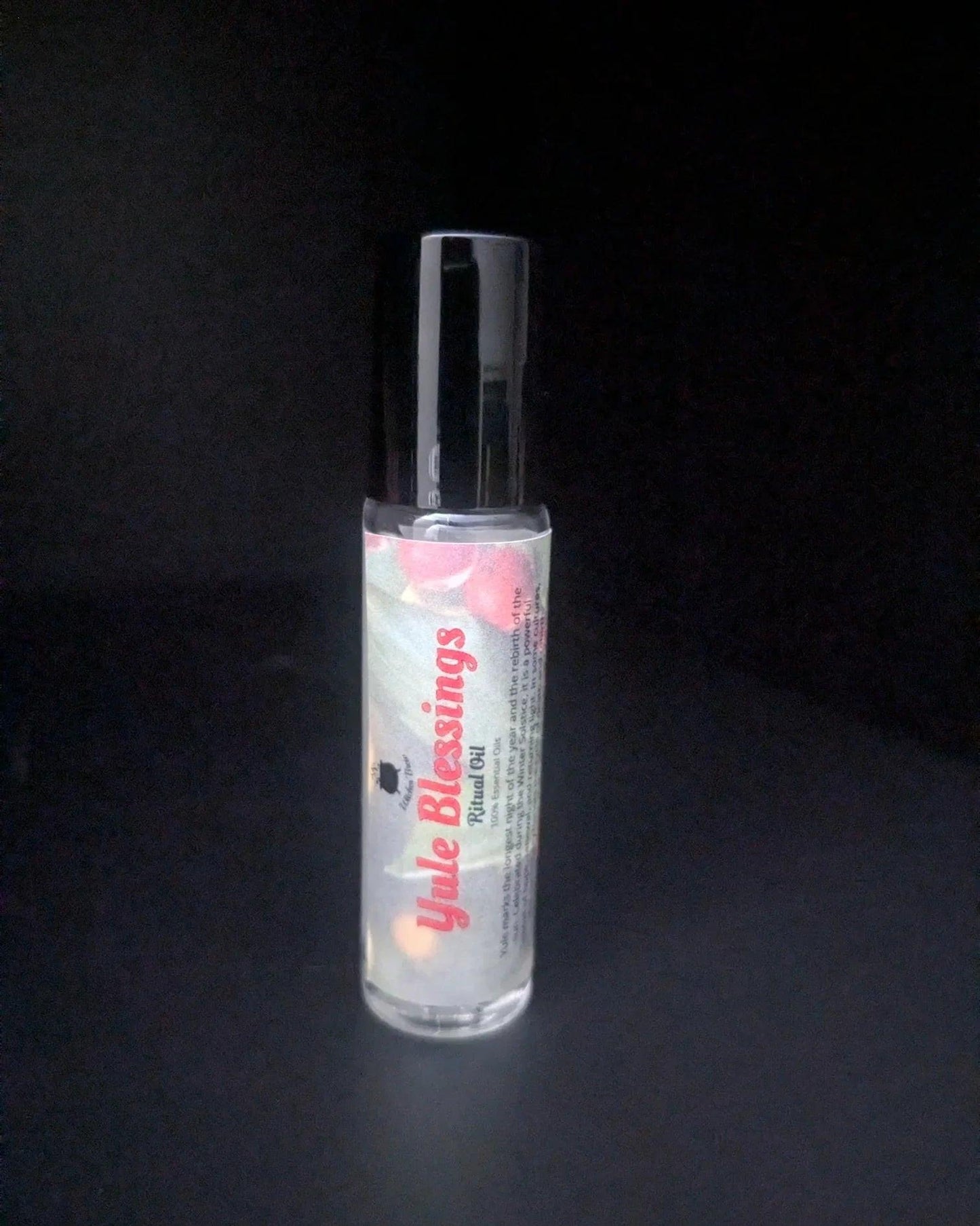 Yule Blessings ritual oil bottle on black background, sustainable witchcraft essential oil
