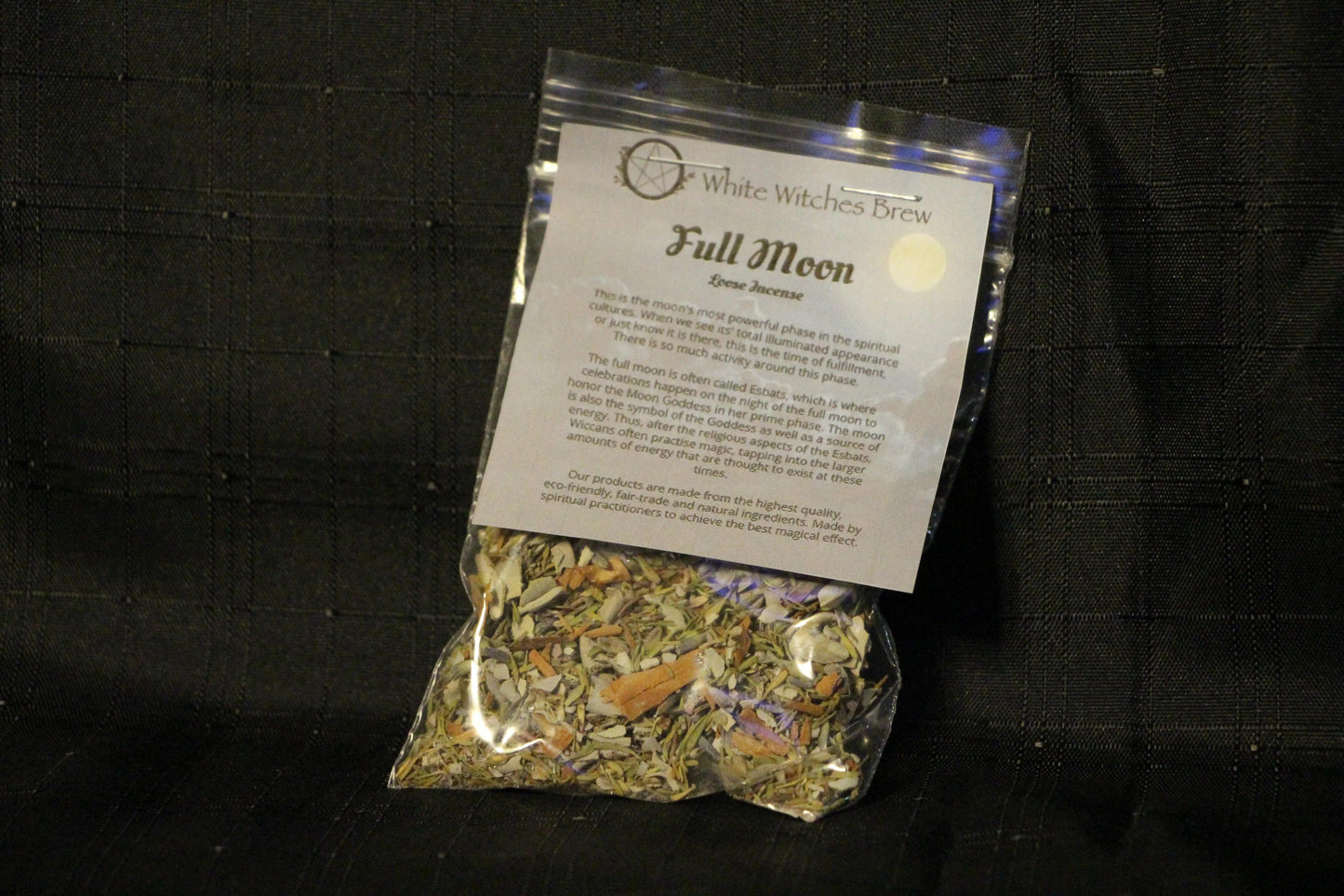 White Witches Brew Full Moon loose incense bag with natural herbs on black fabric background