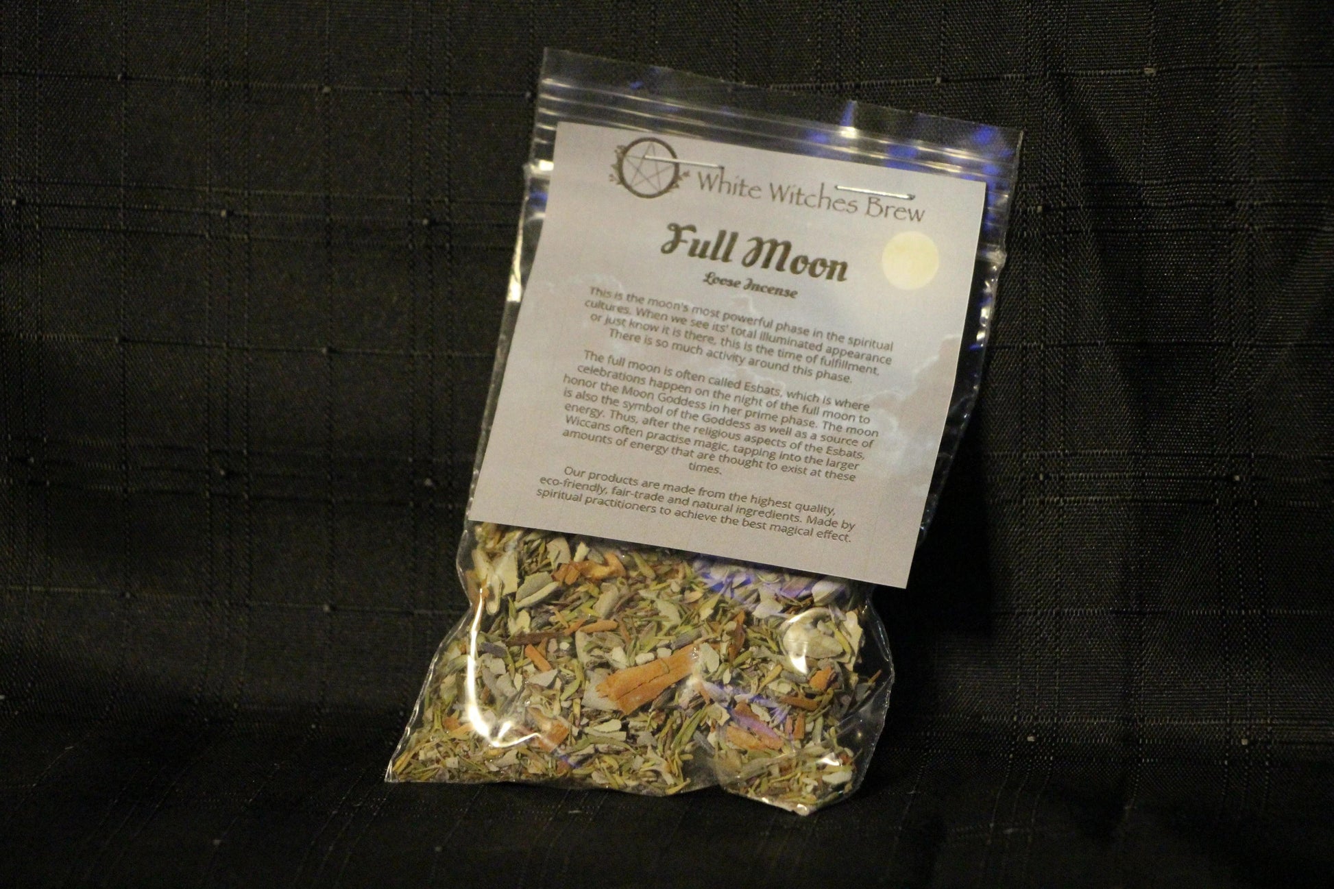 White Witches Brew Full Moon loose incense bag with natural herbs on black fabric background