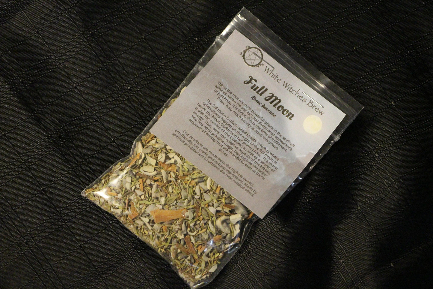 White Witches Brew Full Moon loose incense bag on black textured fabric
