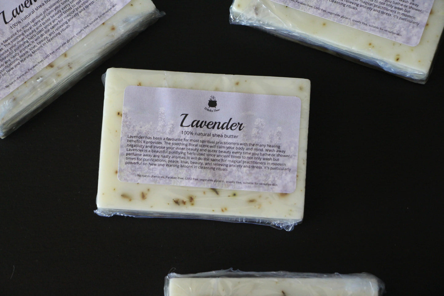 Lavender shea butter soap bars with natural exfoliating particles on black surface