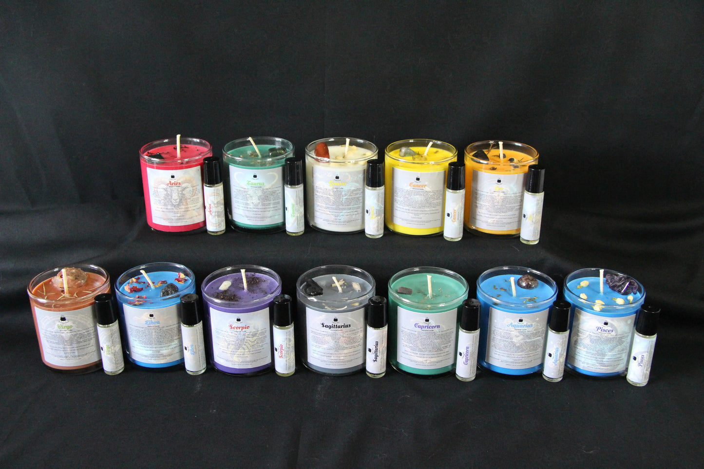Zodiac crystal candles and essential oils on black background, Witches' Brew hand-crafted goods