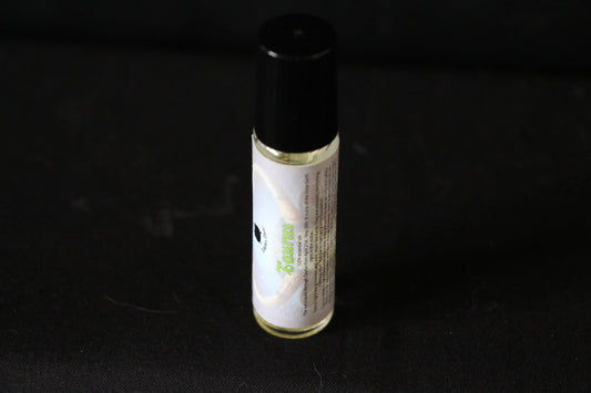 Hand-crafted Taurus essential oil roller bottle on black background, Witches' Brew