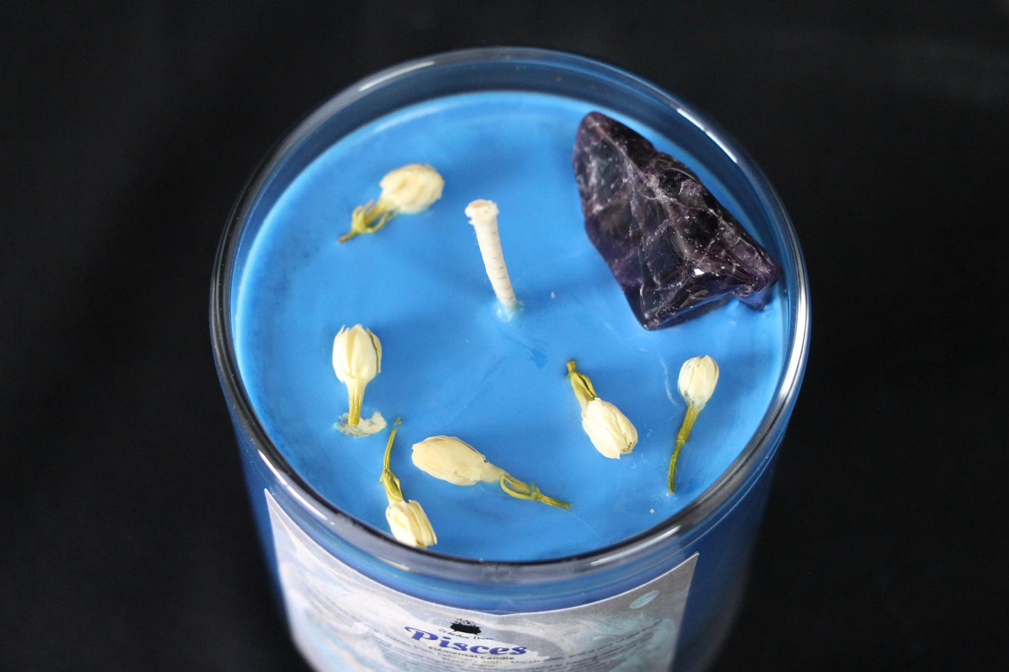 Blue crystal candle with amethyst and dried flowers in glass jar, Witches' Brew ritual decor