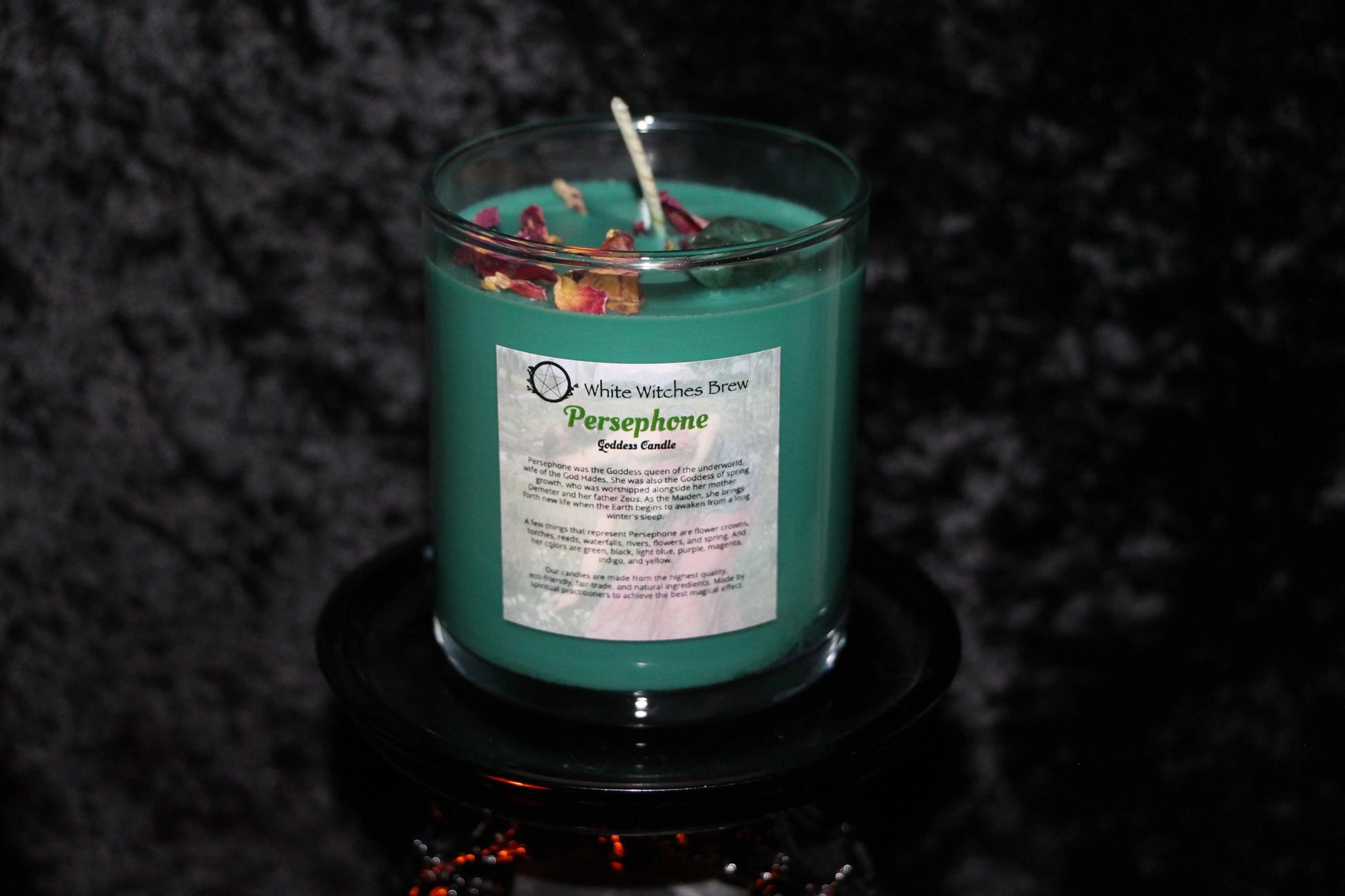 Hand-crafted green Persephone goddess candle with dried flower petals, Witches' Brew branding.