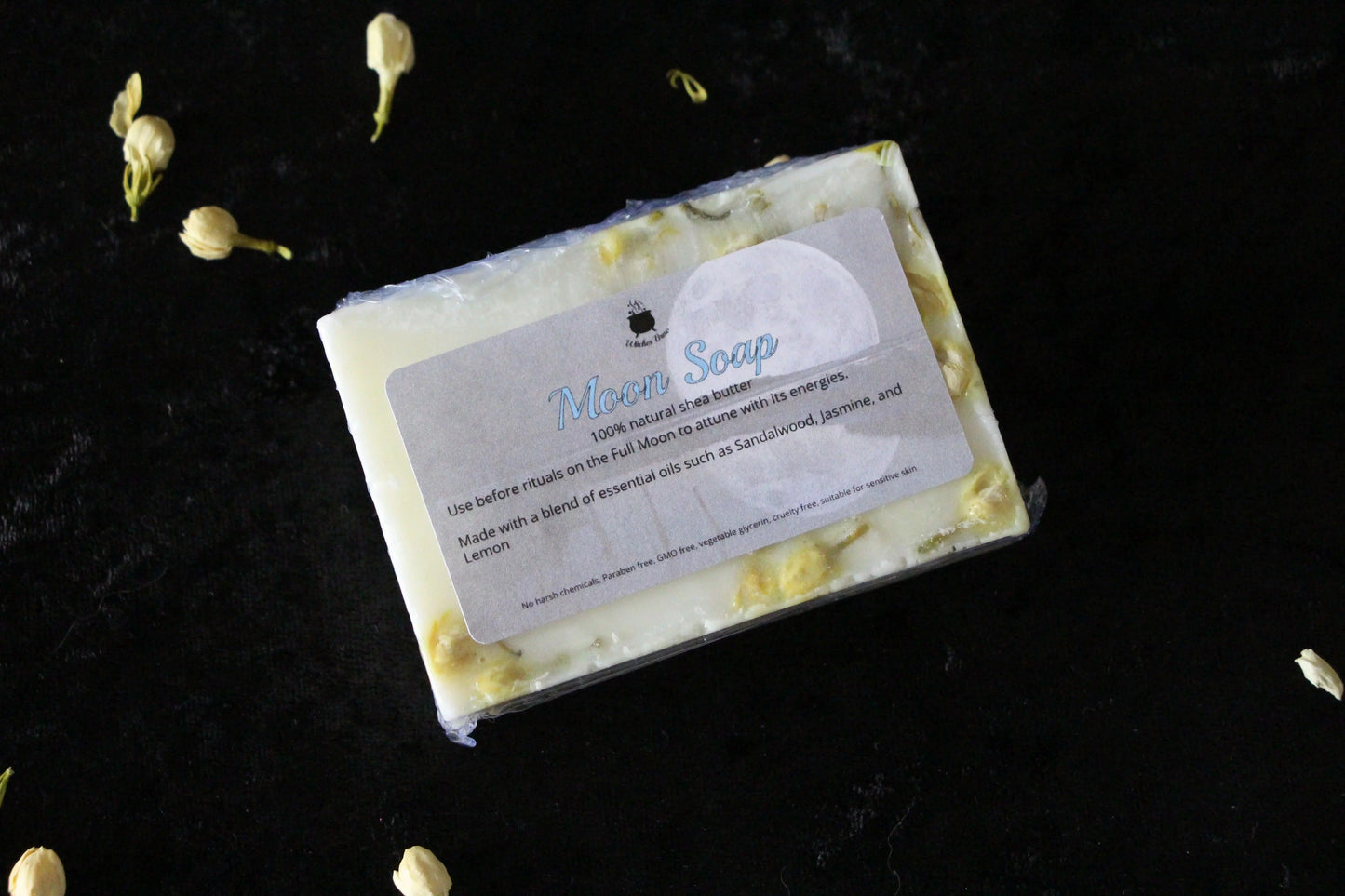 Moon Soap bar with natural botanicals on black velvet, sustainable ritual skincare