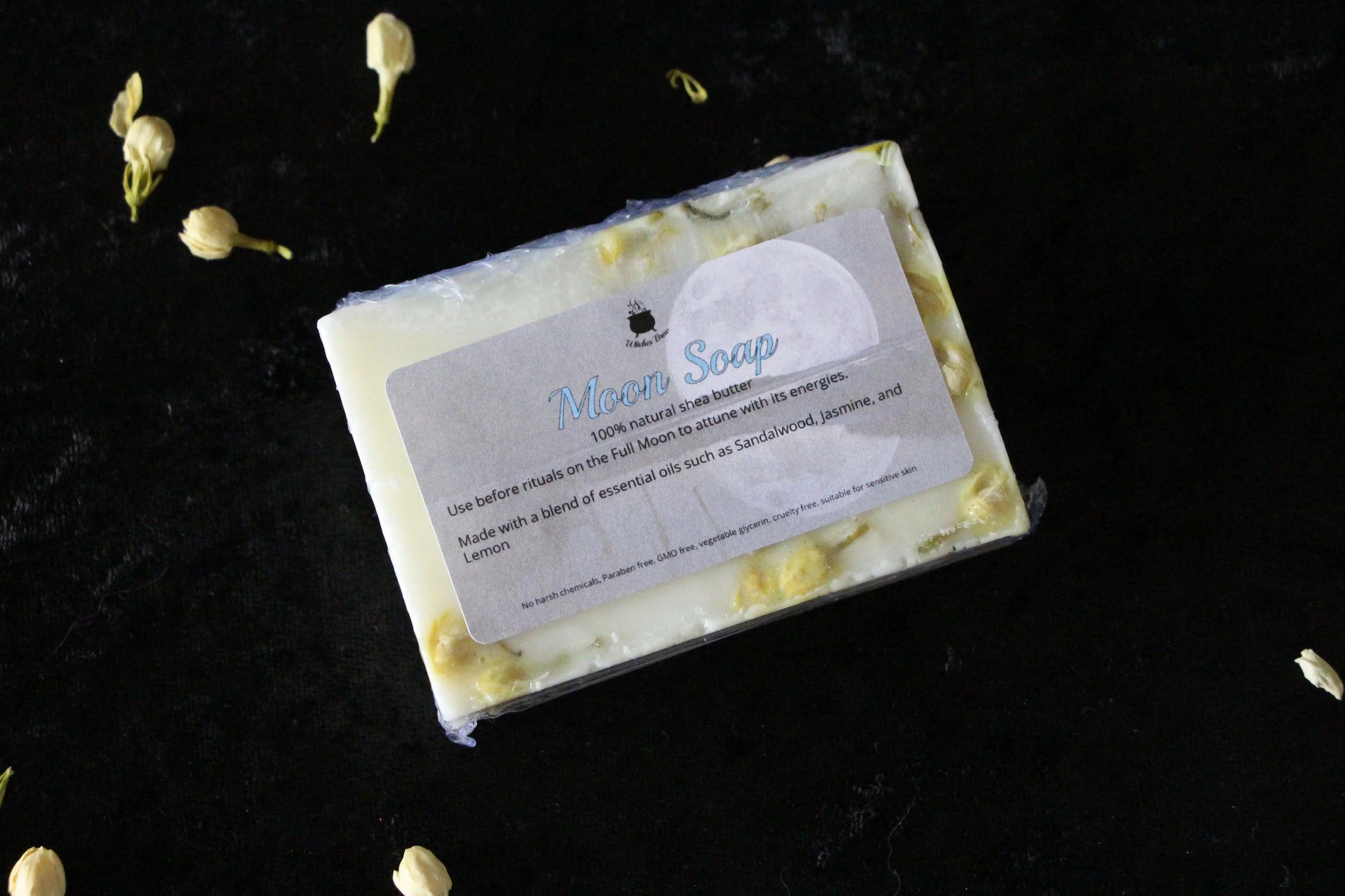 Moon Soap bar with natural botanicals on black velvet, sustainable ritual skincare