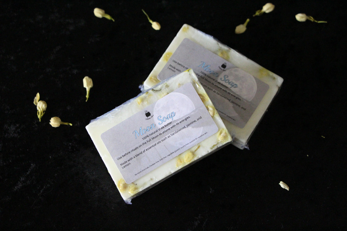 Handcrafted Moon Soap bars with botanicals on black velvet, sustainable ritual goods