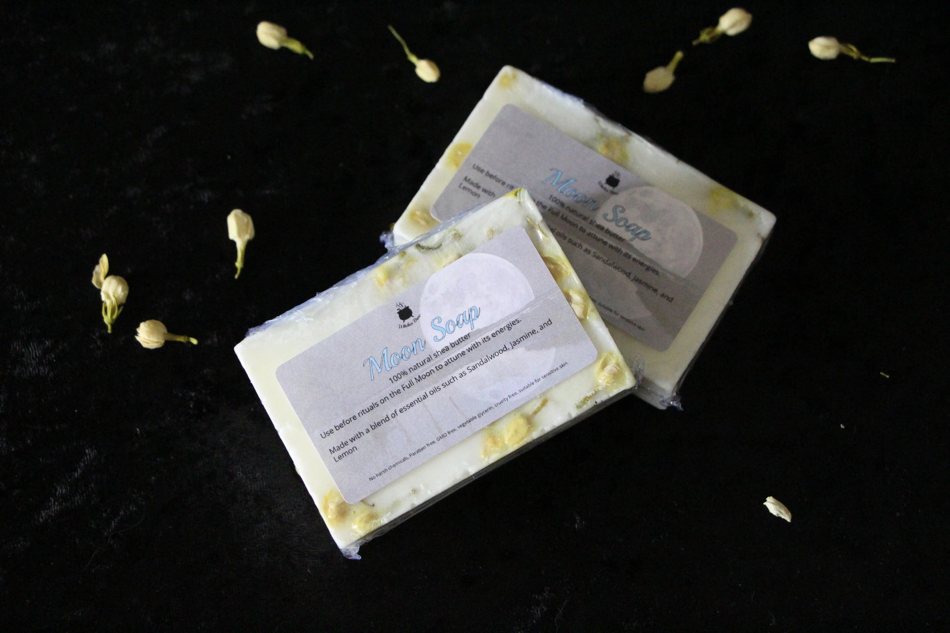Handcrafted Moon Soap bars with botanicals on black velvet, sustainable ritual goods