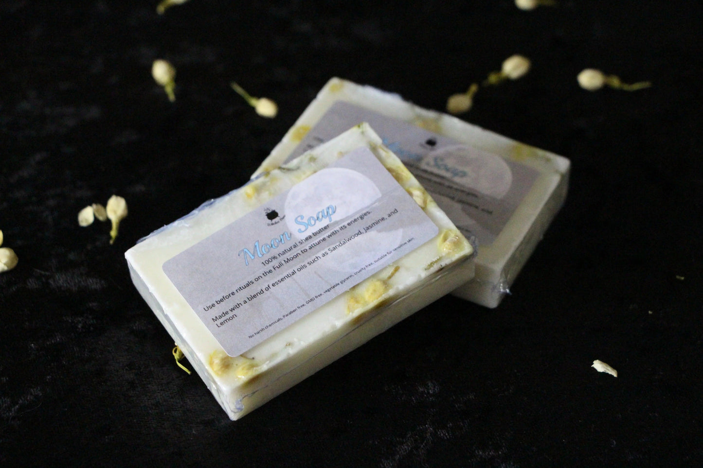 Handcrafted Moon Soap bars with natural flowers on black velvet, Witches' Brew ritual tools