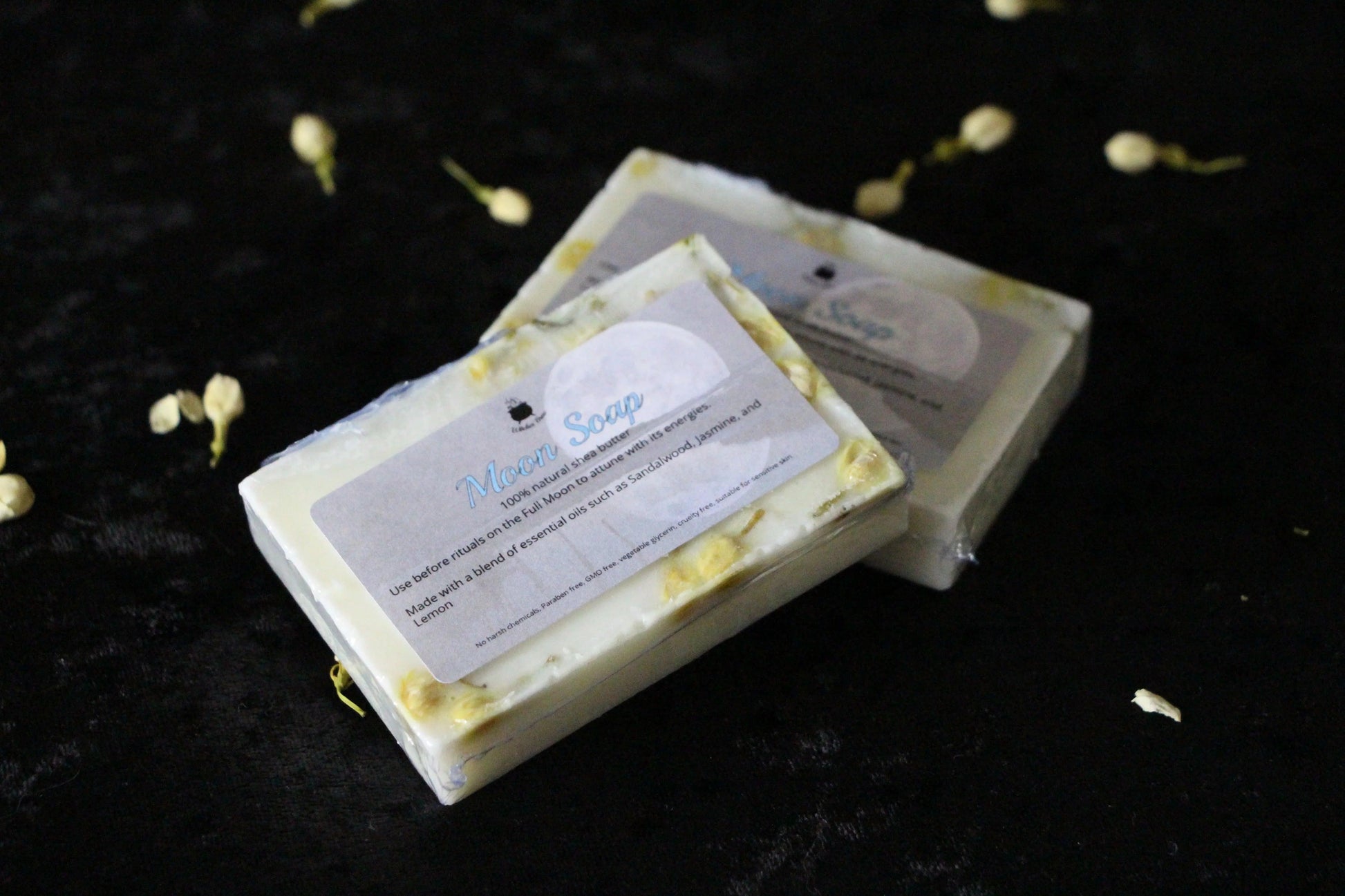 Handcrafted Moon Soap bars with natural flowers on black velvet, Witches' Brew ritual tools