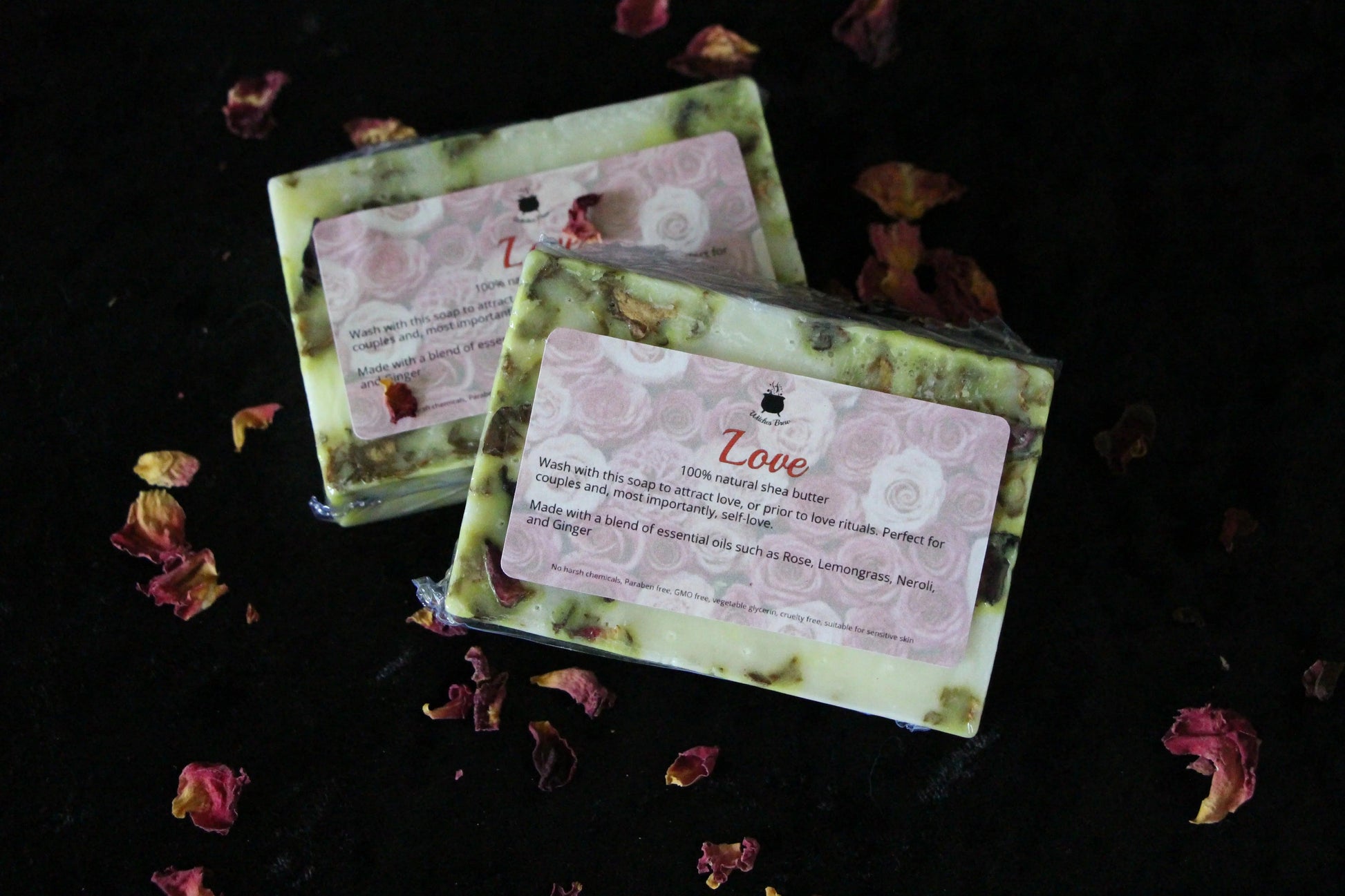 Handcrafted Love ritual soap bars with rose petals on dark background, Witches' Brew