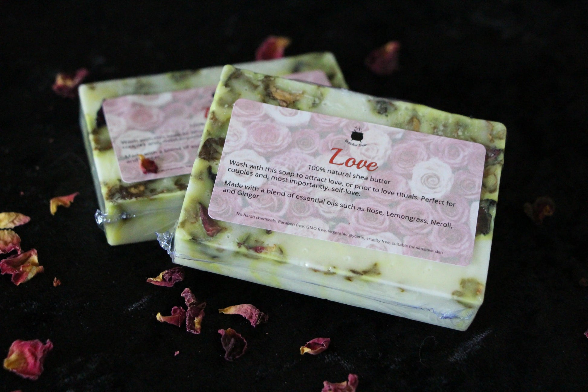 Handcrafted Love soap bar with rose petals on black cloth, sustainable witch-crafted gift