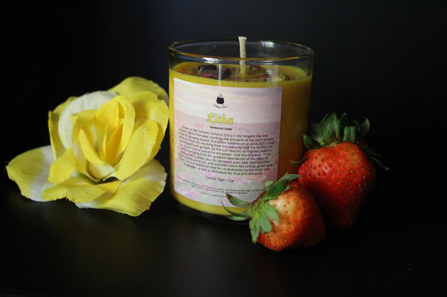 Yellow Litha crystal candle with yellow flower and fresh strawberries, Witches' Brew ritual decor