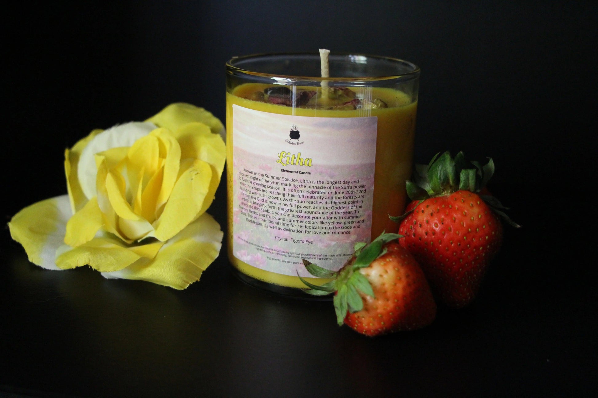 Yellow Litha crystal candle with yellow flower and fresh strawberries, Witches' Brew ritual decor