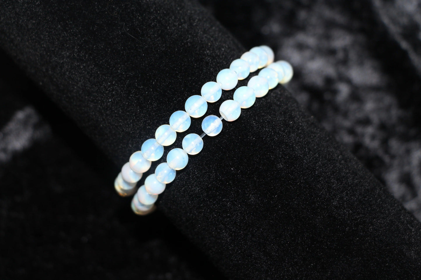 Opalite crystal bead bracelet on black velvet background