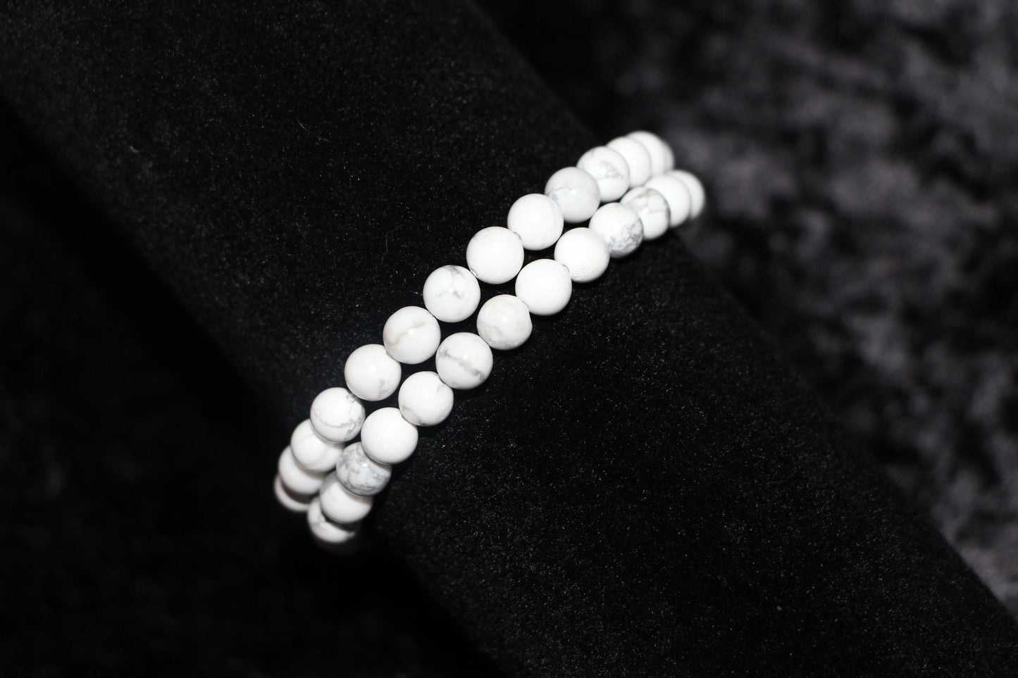 Double strand white crystal bead bracelet on black velvet background