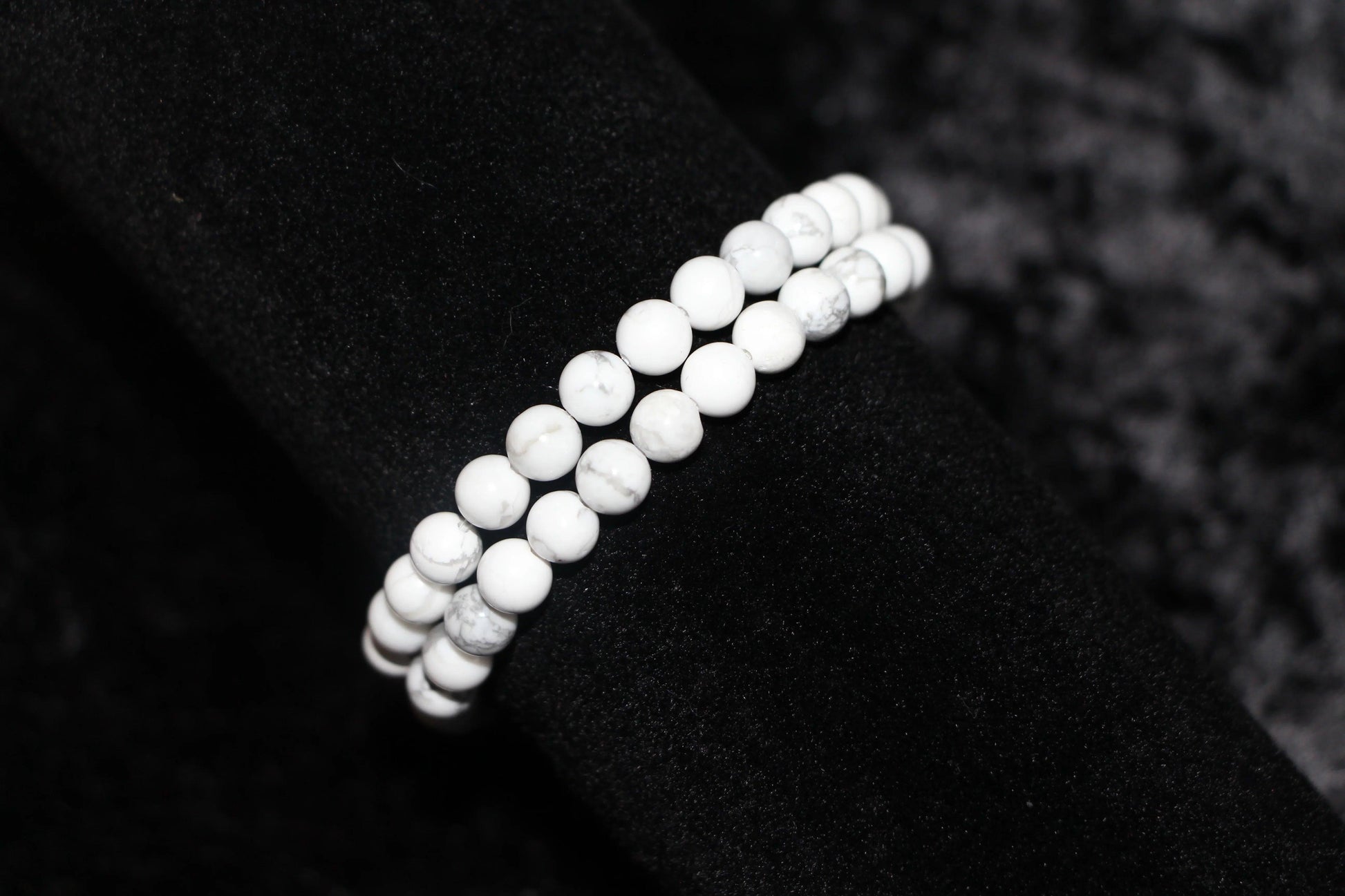 Double strand white crystal bead bracelet on black velvet background