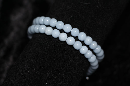 Light blue crystal beaded bracelet on black velvet background