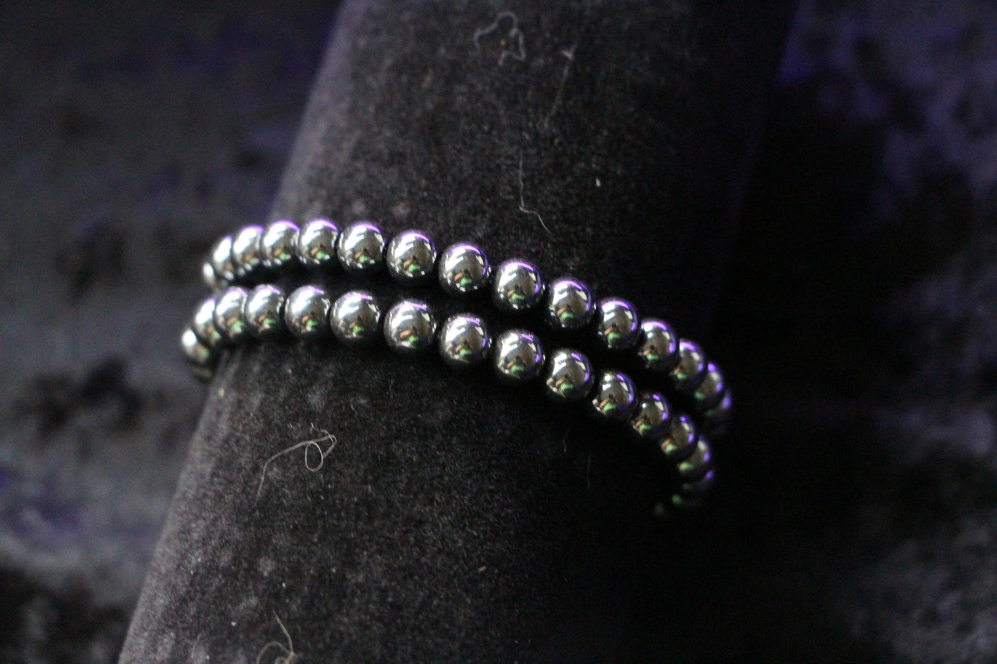 Double strand hematite beaded bracelet on black velvet background, witchy jewelry