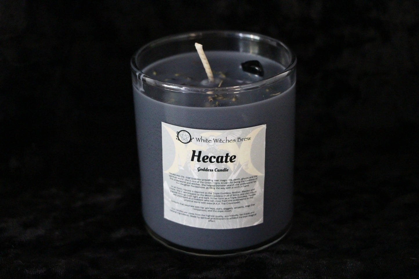 Gray Hecate Goddess Candle by White Witches Brew in clear glass jar on black background