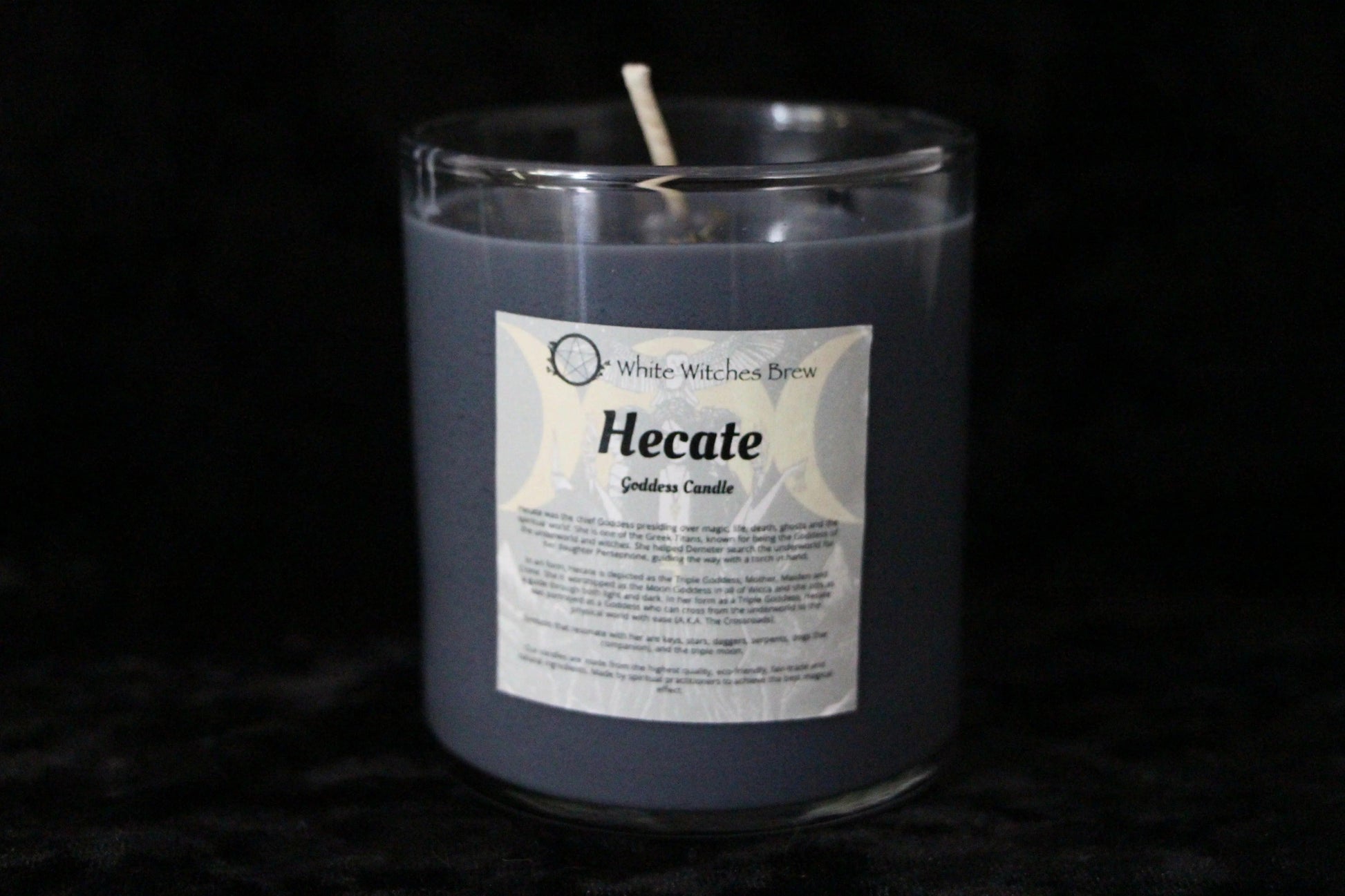 Gray White Witches Brew Hecate Goddess Candle in transparent glass jar on black background