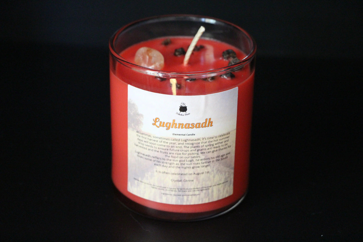 Handmade red Lughnasadh crystal candle with herbs and citrine, Witches' Brew shop.