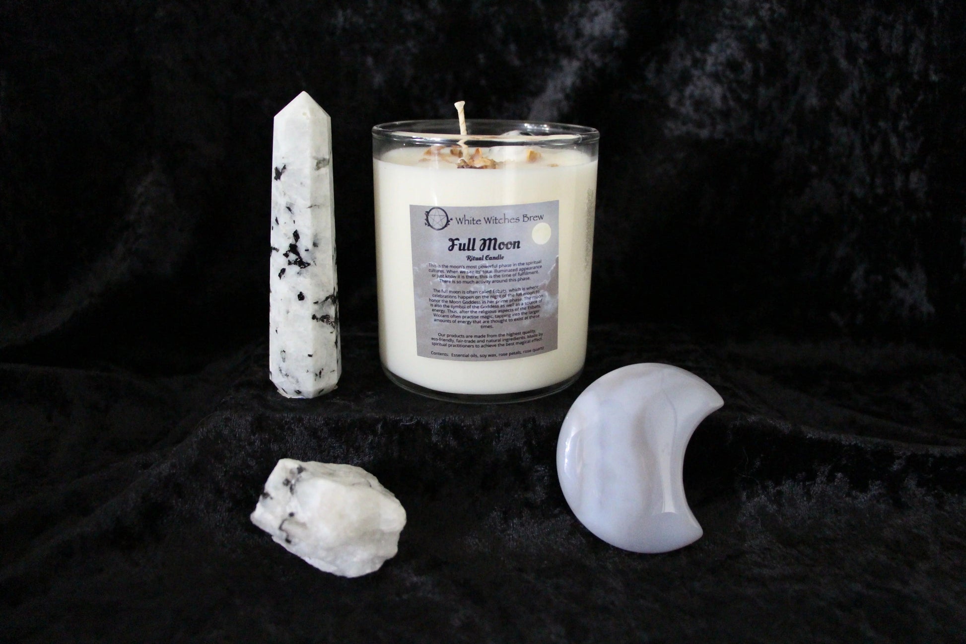 Full Moon ritual candle with white quartz crystals and black velvet background