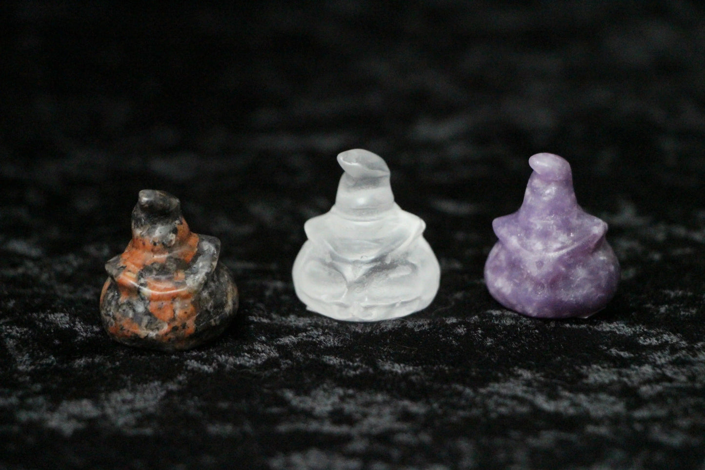 Crystal witch figurines in orange, clear, and purple on black velvet, Witches' Brew decor