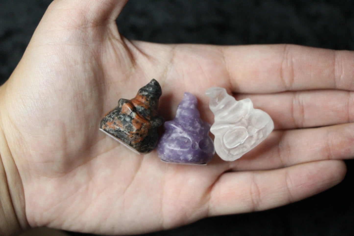 Hand holding three crystal witch hats for modern witchcraft rituals