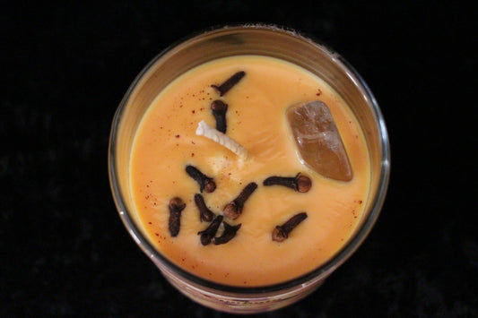 Hand-crafted ritual candle with cloves and crystal on yellow wax, Witches' Brew