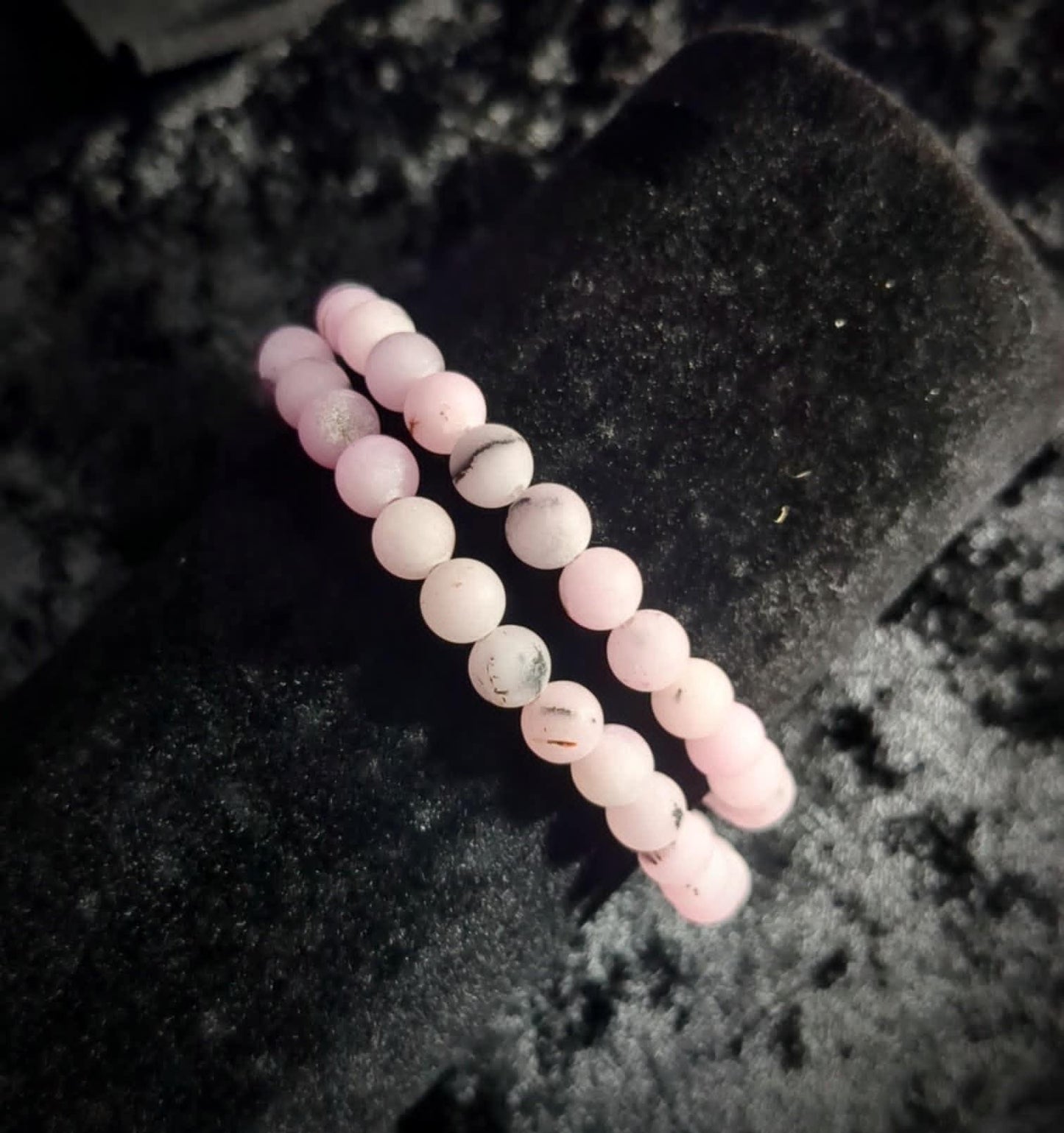 Pink crystal bead bracelets on black velvet, minimalist witch jewelry