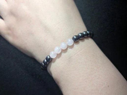 Crystal bead bracelet with black and translucent stones on wrist, modern witch jewelry