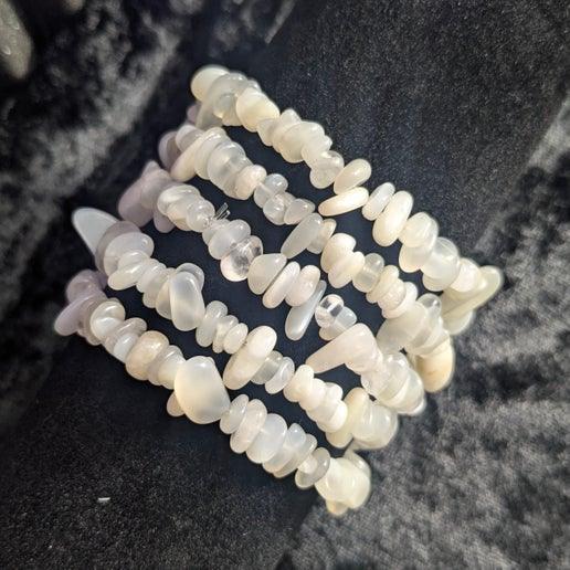 Stretch bracelet made of white crystal chip beads on black velvet display