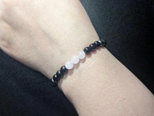 Black and rose quartz crystal bead bracelet on wrist, minimalist witch jewelry
