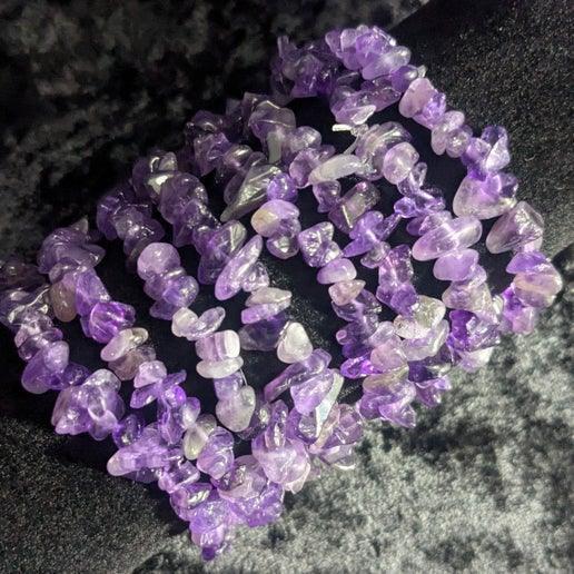 Purple amethyst chip crystal bracelets displayed on a black velvet background
